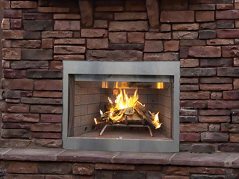 Outdoor Wood fireplace installed within brick