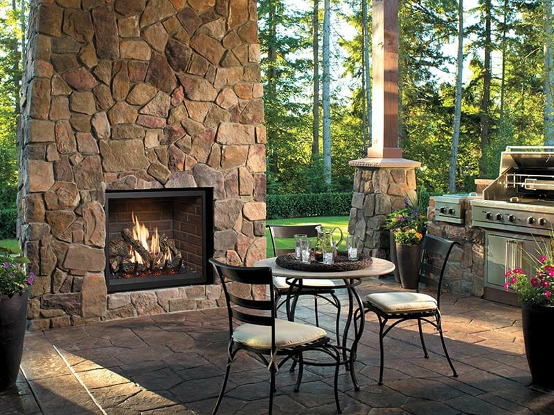 Outdoor Gas Fireplace with trees and table