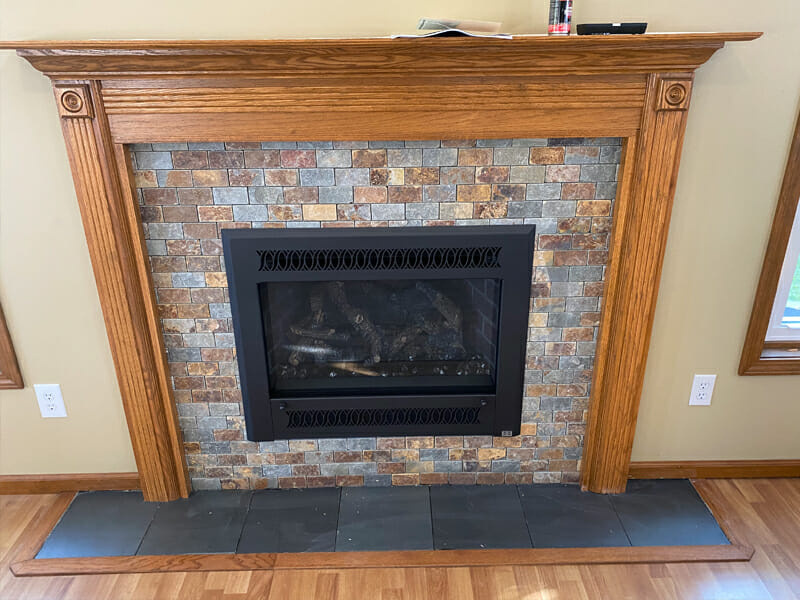 Fireplace installed in brick with wood design