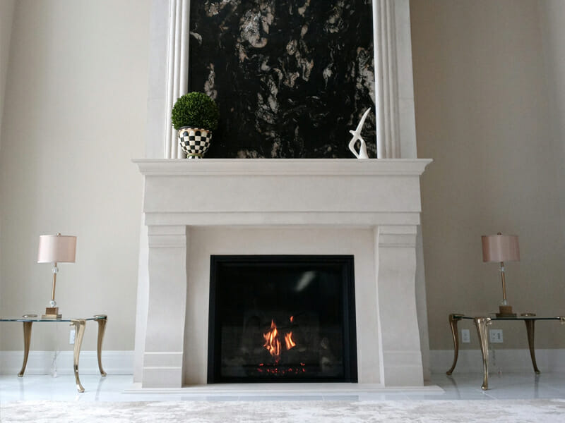 White fireplace with glass coffee tables and lamps on each side