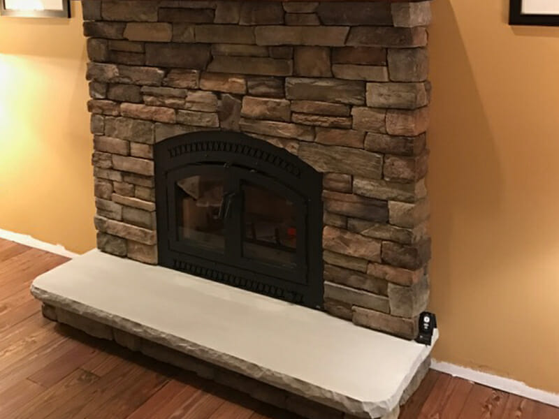 A fireplace with stone inlay on each side