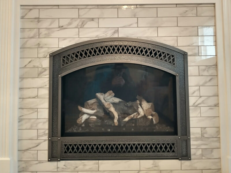 Fireplace installed in brick marble wall