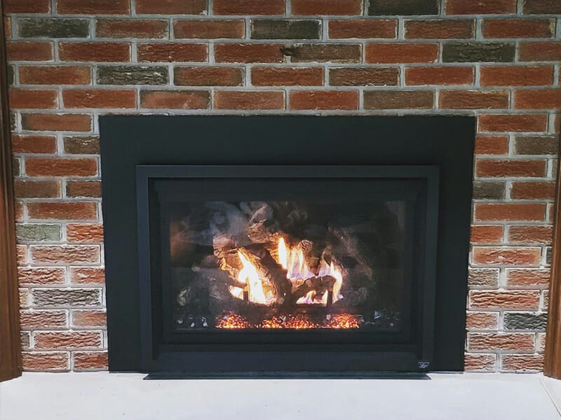Built in fireplace in a home burning